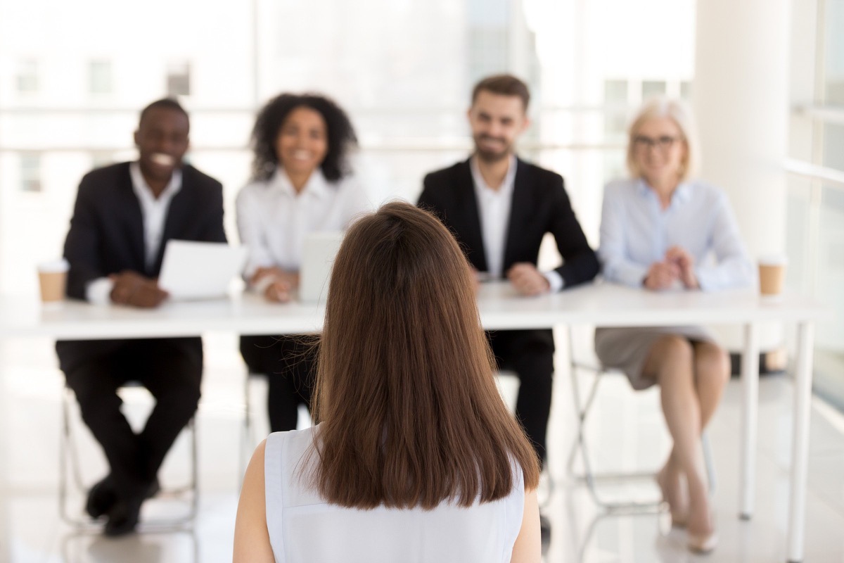 A candidate in an interview with a hiring panel